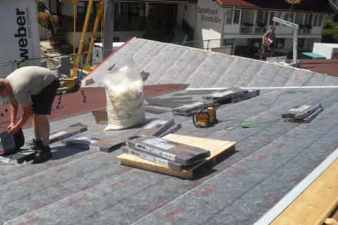 Shingle bundles on a roof waiting to be installed