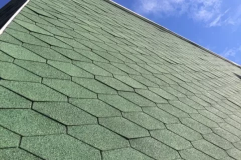 Buckled shingles on façade due to installation error